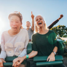 attraction-522554200 people riding a roller coaster