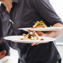 restaurant_168427217 server holding plates of food